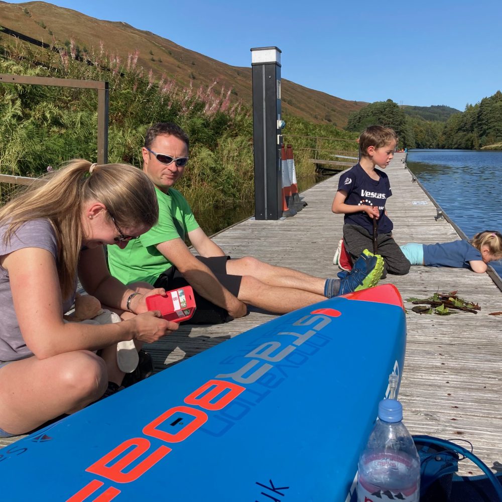 Sup racer resting at a checkpoint during the Great Glen Paddle Challenge